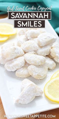 a white plate topped with cookies and lemon slices