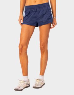 These Nylon Shorts Offer Both Style And Comfort, Making Them Perfect For A Sporty Yet Fashionable Look. They're Ideal For Any Activity, Ensuring You Feel Comfortable And Confident Throughout Your Entire Day. Shorts. Elastic Waist. Side Stripes. 100% Nylon. Model Wears Size S. Model Height Is 5'9. Item Care: Wash With Similar Color. | Edikted Nikki Nylon Shorts Sporty Nylon Bottoms With Built-in Shorts, Sporty Nylon Shorts, Casual Nylon Athletic Shorts For Spring, Casual Nylon Shorts, Casual Short Nylon Bottoms, Stretch Nylon Shorts For Streetwear, Casual Nylon Athletic Shorts, Nylon Bottoms With Elastic Waistband, Short Length, Nylon Bottoms With Elastic Waistband