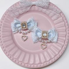 two little bows with pearls and lace on a pink plate, one is for girls