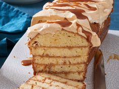 a cake with frosting and caramel drizzle on top is sitting on a plate