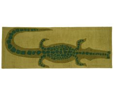 a green rug with an image of a lizard on it's face and legs