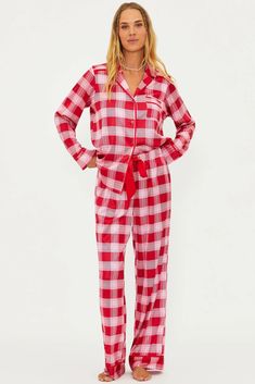 The Livy Top & Connie Pant Set is our new long-sleeve and pant pajama set, perfect for the holiday season. This PJ set is featured in a satin-like, lightweight, and breathable plaid-printed fabrication. It’s all in the details with a button-front top, front pocket, elastic waistband with an adjustable ribbon tie, and red piping. Our Candy Cane Plaid features rich shades of red and pink in a classic holiday plaid.