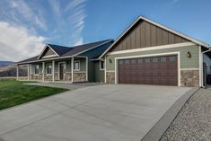 a large house with two garages in the front and one on the other side