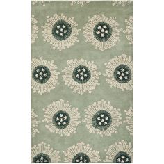 an area rug with green and white flowers on the side, in front of a white background