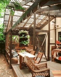 an outdoor patio with wooden furniture and plants