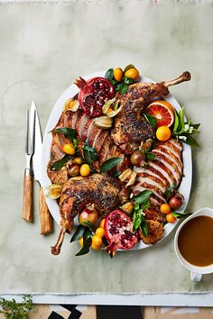 a white plate topped with meat and fruit