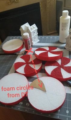 some red and white circles sitting on top of a table next to a pair of scissors