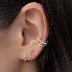 a close up of a person's ear with two different types of piercings