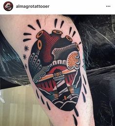 a man's leg with a tattoo on it that has an image of a heart