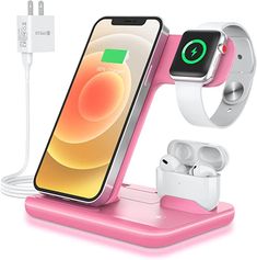 an apple watch and earphones are charging on a pink charger with the dock attached