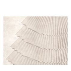 a white rug with wavy lines on the top and bottom, in shades of beige