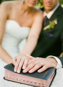 a man and woman are holding hands over a book that says the foundation on which the marriage is built