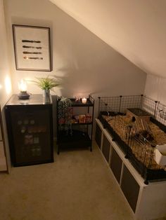 a room with two beds and a desk in it that has candles on top of them