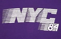 the back of a purple t - shirt with white letters and numbers printed on it