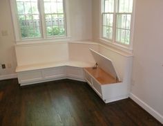 an empty room with white walls and wooden floors