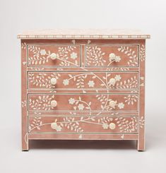 an ornately decorated chest of drawers with flowers and leaves painted on the front side