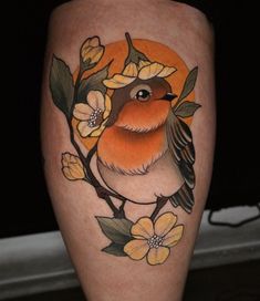 a small bird sitting on top of a branch with flowers around its neck and legs