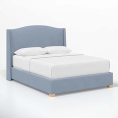 a blue bed with white sheets and pillows