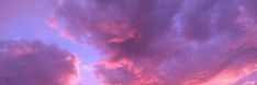 the sky is pink and purple with clouds