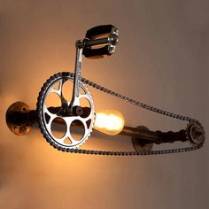 a light that is on the side of a wall with a chain attached to it