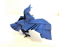 a blue origami bird sitting on top of a table