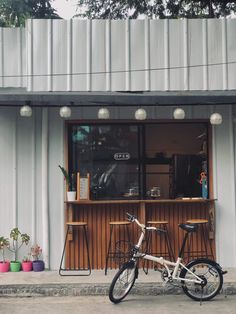 a bike is parked in front of a bar