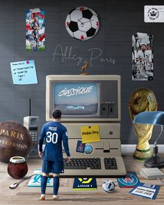 a man standing in front of a computer with soccer memorabilia on the wall behind him