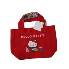 a red hello kitty tote bag with an image of a cat on the front