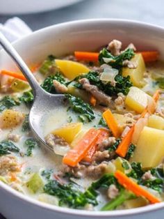 a white bowl filled with soup and vegetables