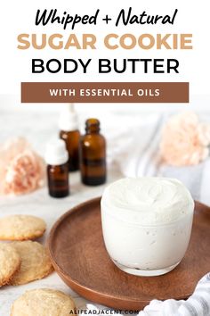 whipped and natural sugar cookie body butter with essential oils on a wooden plate next to cookies