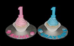 two cupcakes with frosting and one has the number 1 on them,