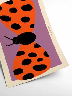 an orange and black lady bug on a purple background