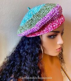 a mannequin head wearing a multicolored crochet knitted hat