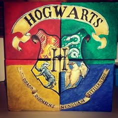 the hogwart's crest is painted on top of four different colored blocks,