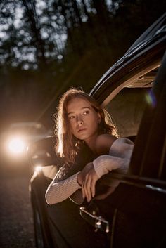 a woman leaning out the window of a car