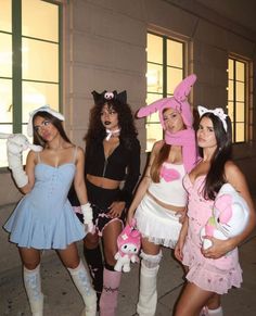 four women dressed up in costumes posing for the camera