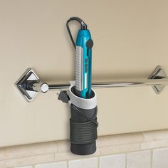 an electric toothbrush holder attached to a wall