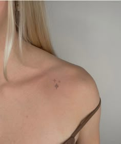 a woman with a small tattoo on her shoulder