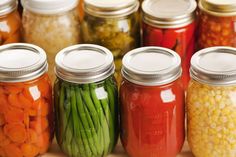 many jars filled with different types of vegetables