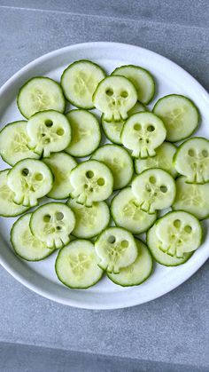 sliced cucumbers arranged on a white plate