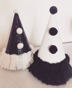 two black and white party hats sitting next to each other