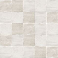 a white tile wall with squares on it