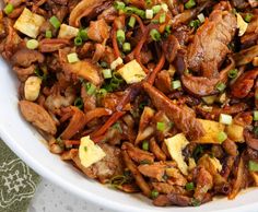 a white bowl filled with meat and veggies