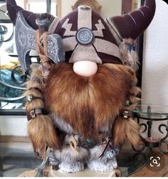 a close up of a stuffed animal with horns and other items on a table in front of a mirror