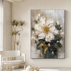 a large white flower painting in a living room