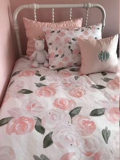 a bed with pink and white flowers on it