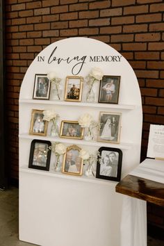 an arch with pictures and flowers on it that says in loving memory, surrounded by other family photos