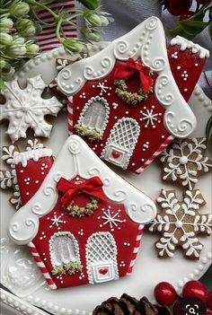 two red and white gingerbread houses on a plate