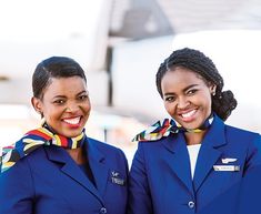 two women in blue uniforms standing next to each other