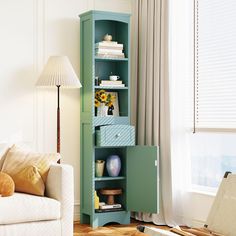 a living room with a white couch and blue bookcase in it's corner